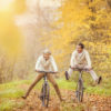 Happy Seniors Riding Bicycles in the Autumn Woods.