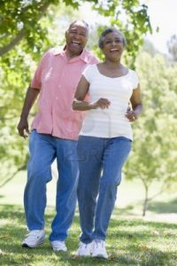 African American couple walking in the park on a sunny spring day.