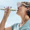 Senior woman drinking from water bottle