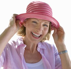 Smiling senior woman wearing colorful sun hat