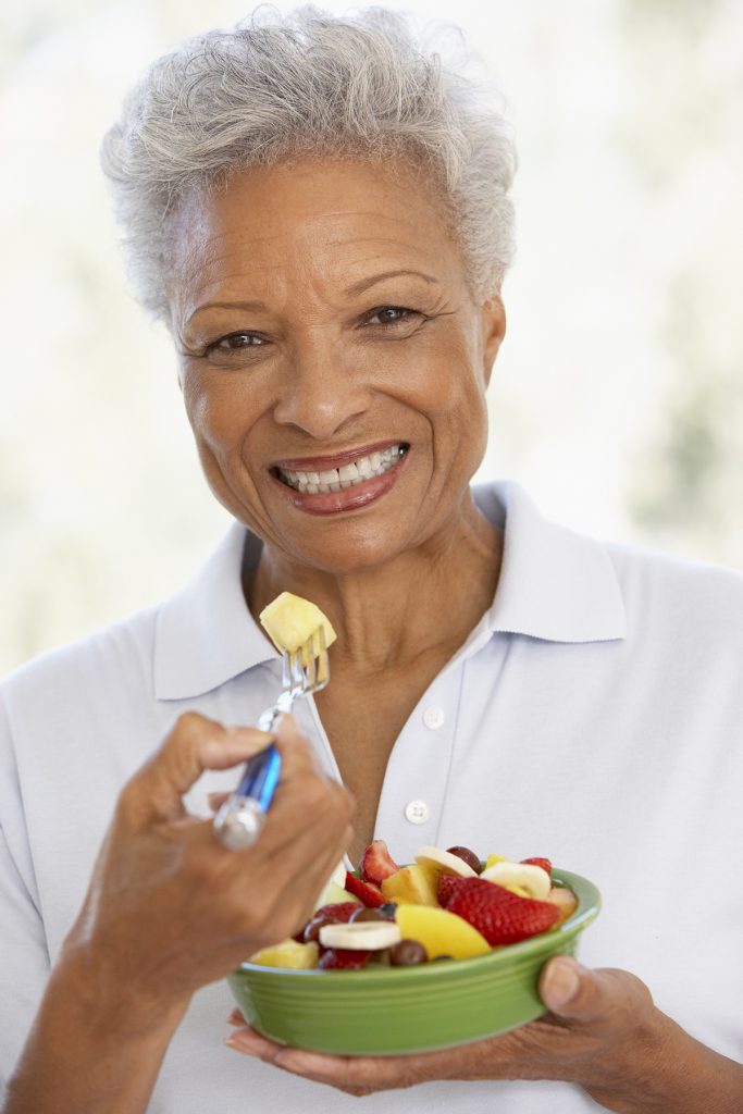 Senior Adult Eating A Fresh Fruit Salad