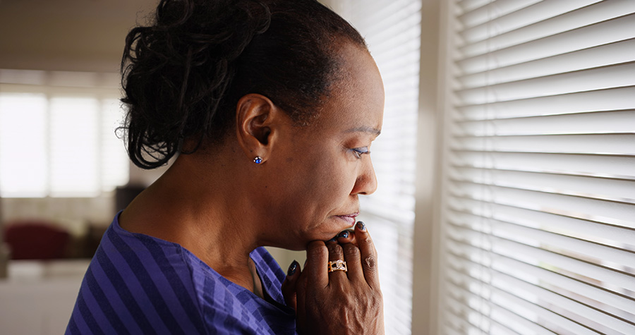 Depression African American Woman looking out the window.